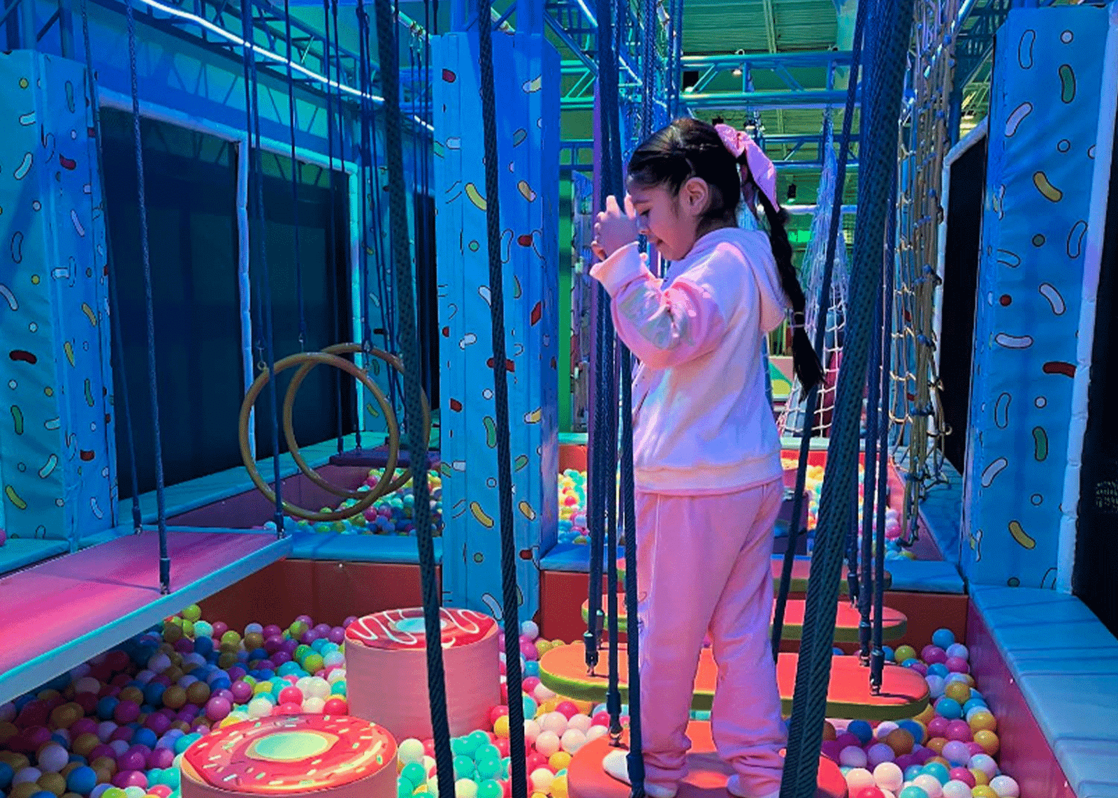 Kids playing around the glowing candy carousel at Candeeland McAllen